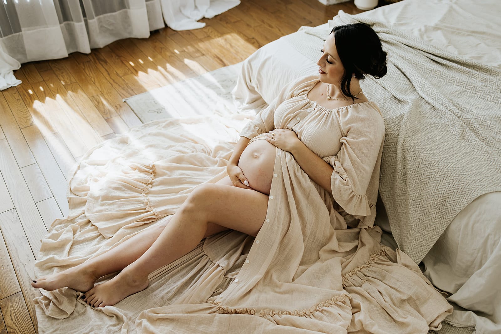 expecting mother wears client closet gown for her maternity photos in calgary studio